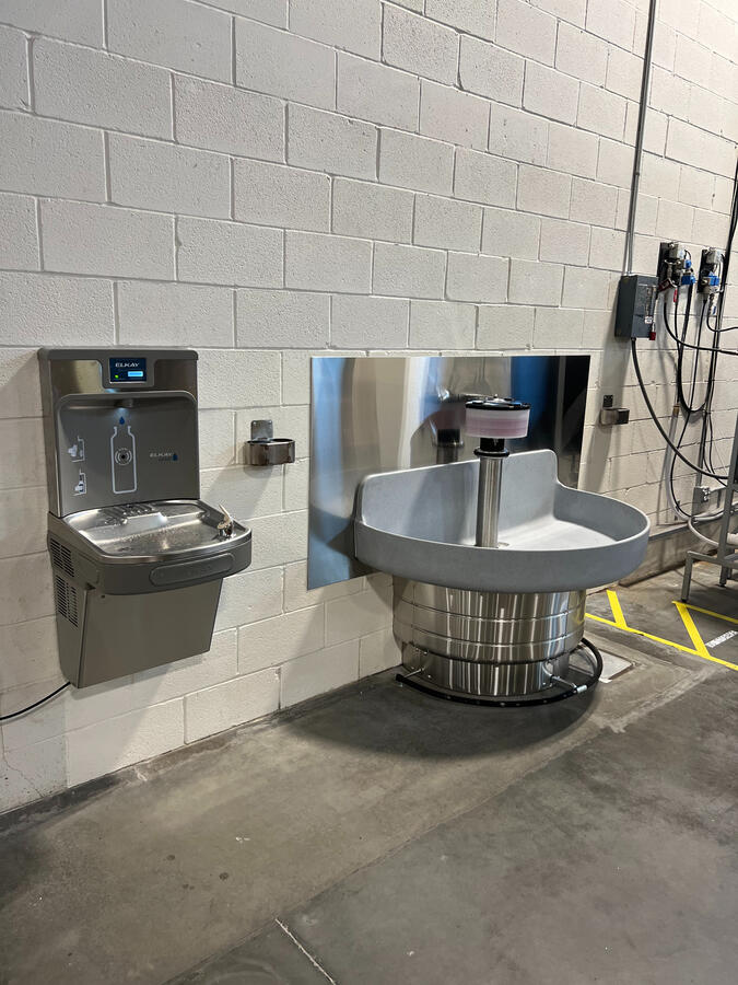 Outdoor drinking fountains mounted on cinderblock wall