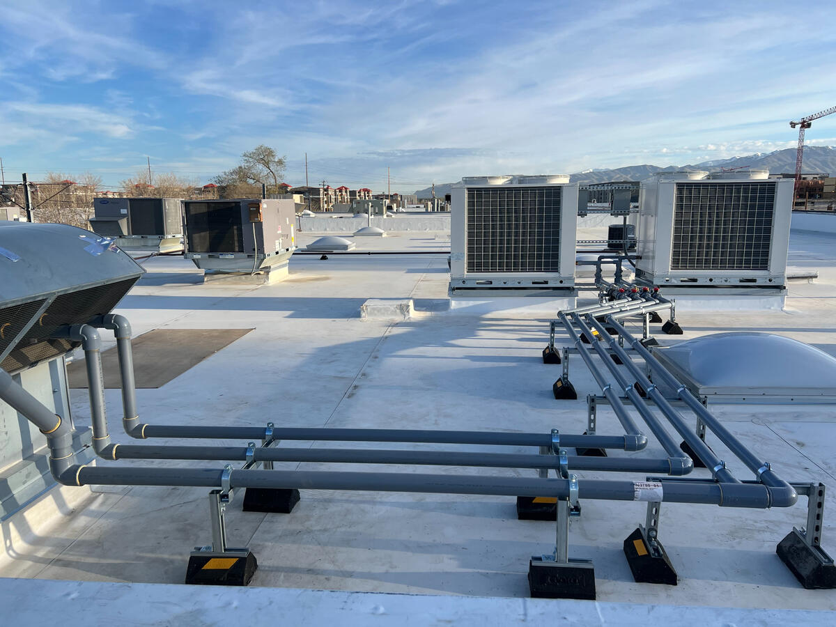 Multiple rooftop piping systems with conduit supports