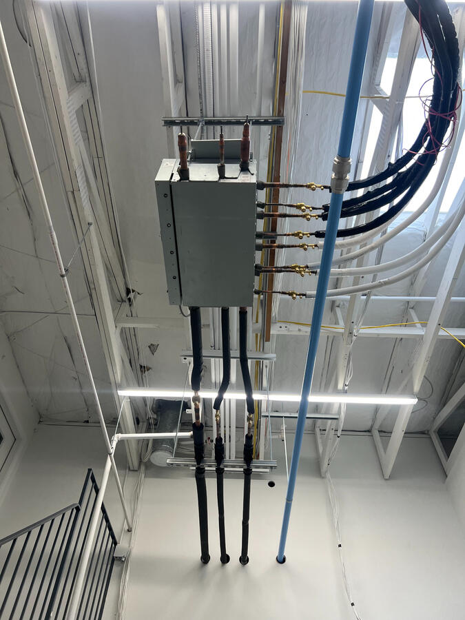 Ceiling-mounted mechanical piping installation in commercial interior